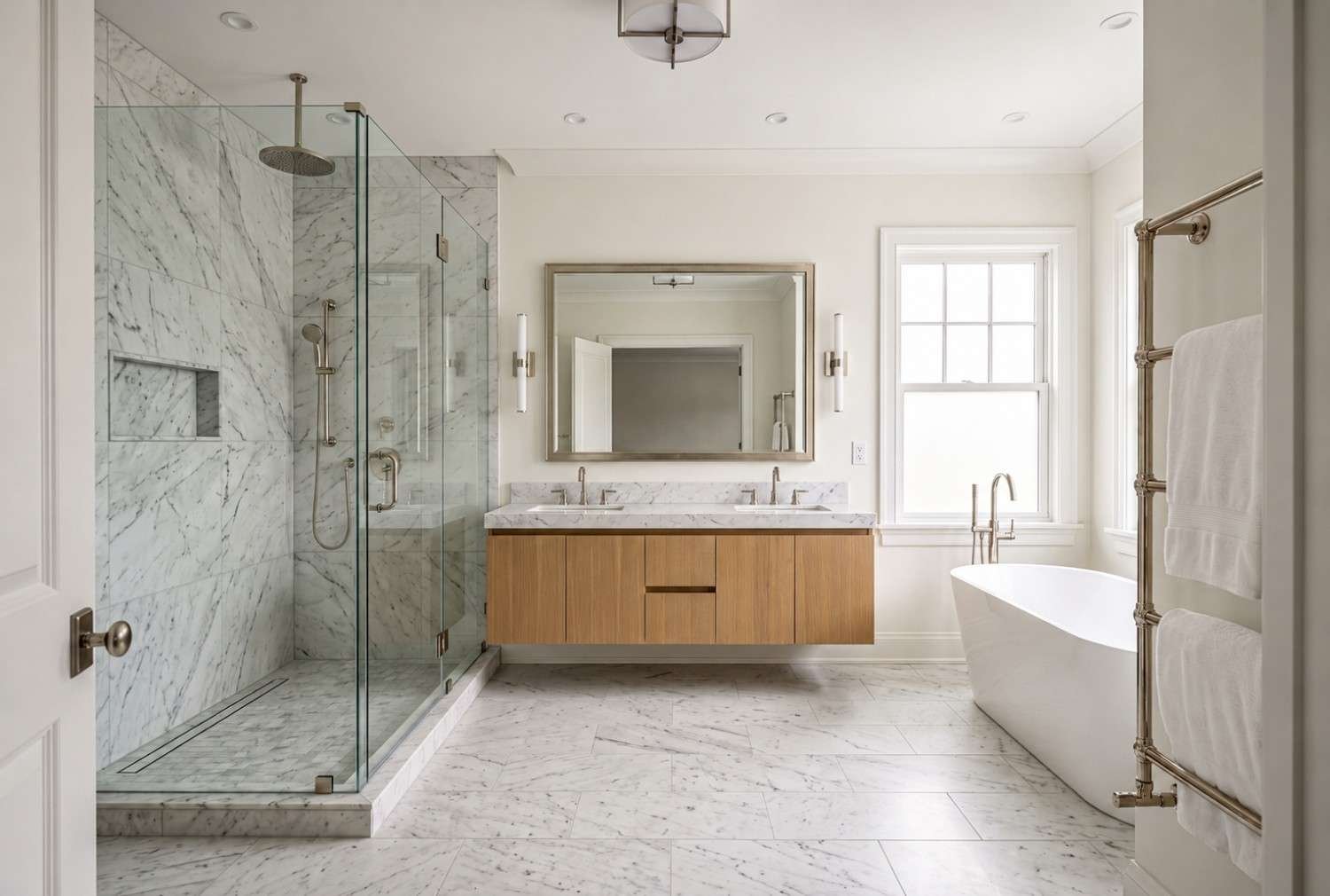 Modern luxury bathroom with marble shower and freestanding tub.
