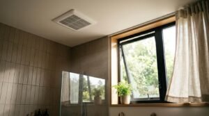 Ceiling exhaust fan and operable awning window for bathroom moisture control and ventilation